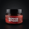 Rocky Spoon Piri Piri pikantiškas padažas stiklainyje ant tamsaus fono / Rocky Spoon Piri Piri spicy sauce jar on dark background premium product photo